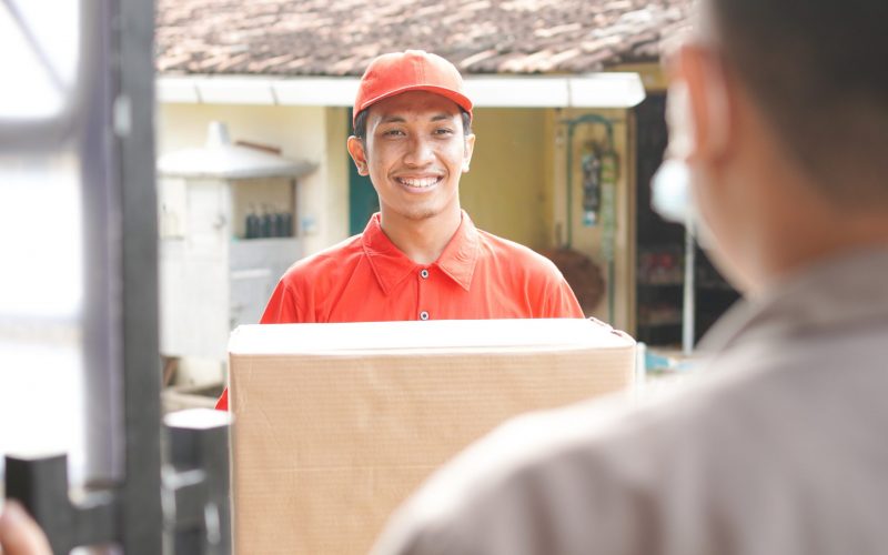 delivery man delivers the box to the customer